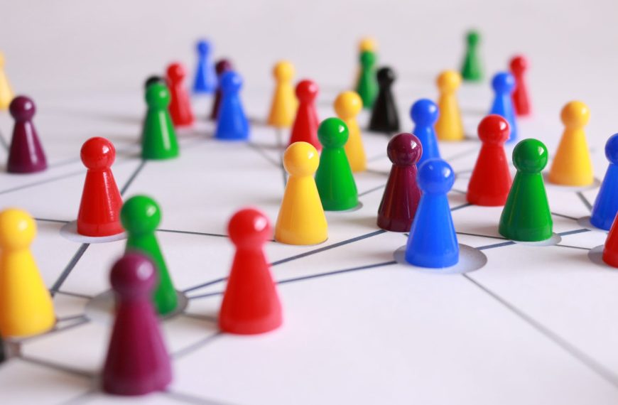 close up photography of yellow green red and brown plastic cones on white lined surface